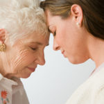 Mother and daughter look intently while considering caregiver choices